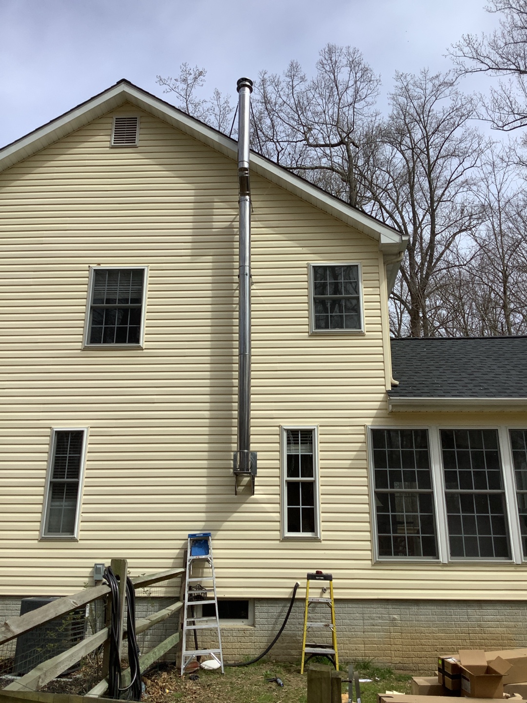 Stainless steel chimney pipe secured with metal brackets